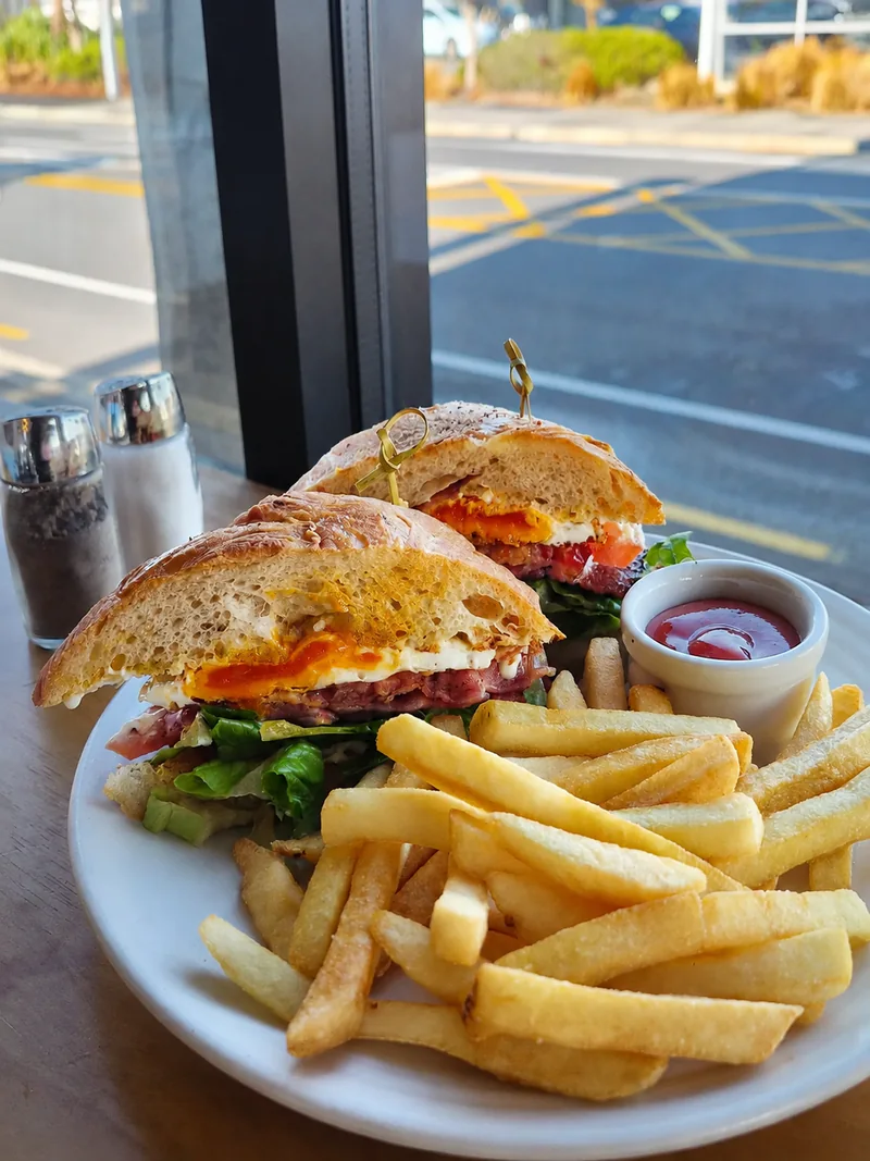A filled sandwich with fries at Yellow