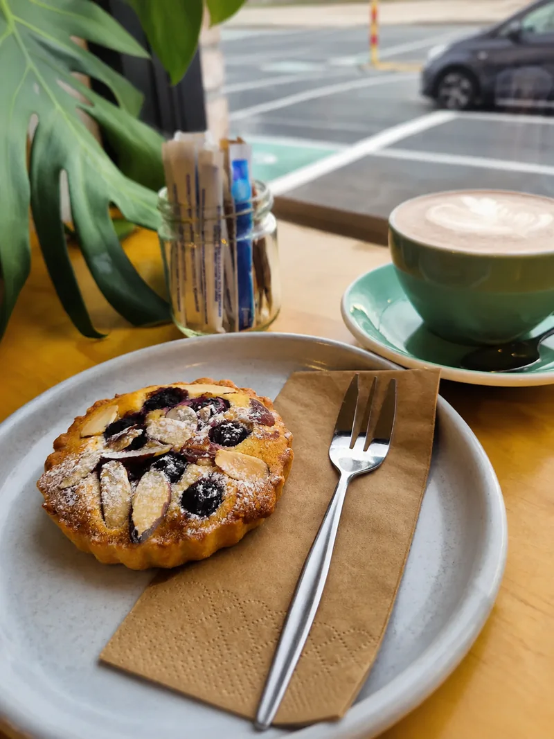 Berry tart and a green cup of coffee at Yellow